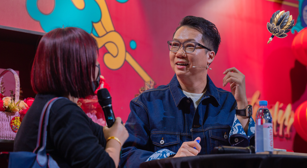 Joey Yap listening to an audience member during a live event Q&A, reflecting on family, care, and knowing when to stop helping.