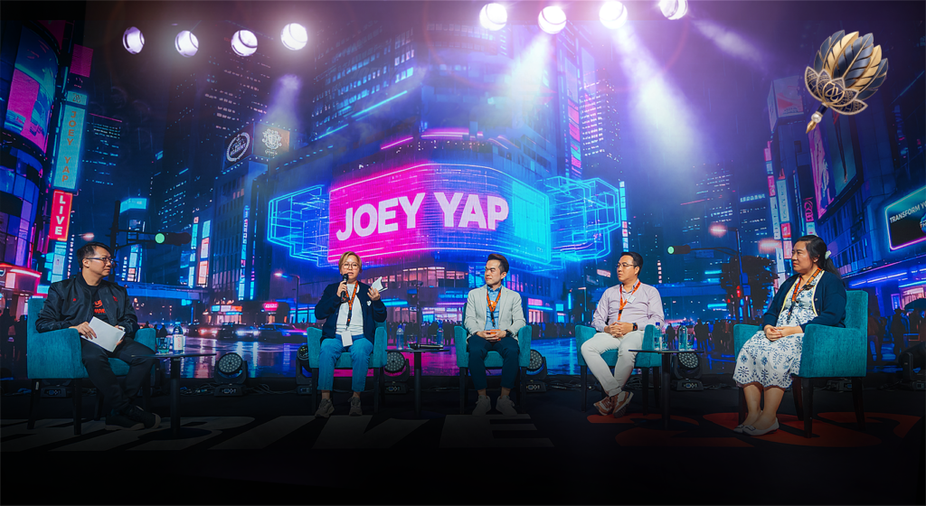 Joey Yap leads a five-person panel discussion on stage, illustrating the leadership team dynamics covered in the Ten Gods framework
